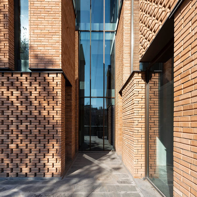 Zomorrod 11 by Ákaran Architects in Tehran is a stack of four cubes, brick and glass facades on the move.